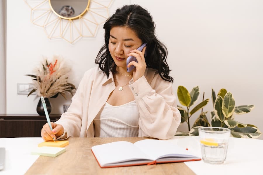 woman working at desk on phone