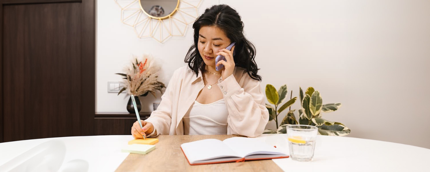 Woman working at desk on phone